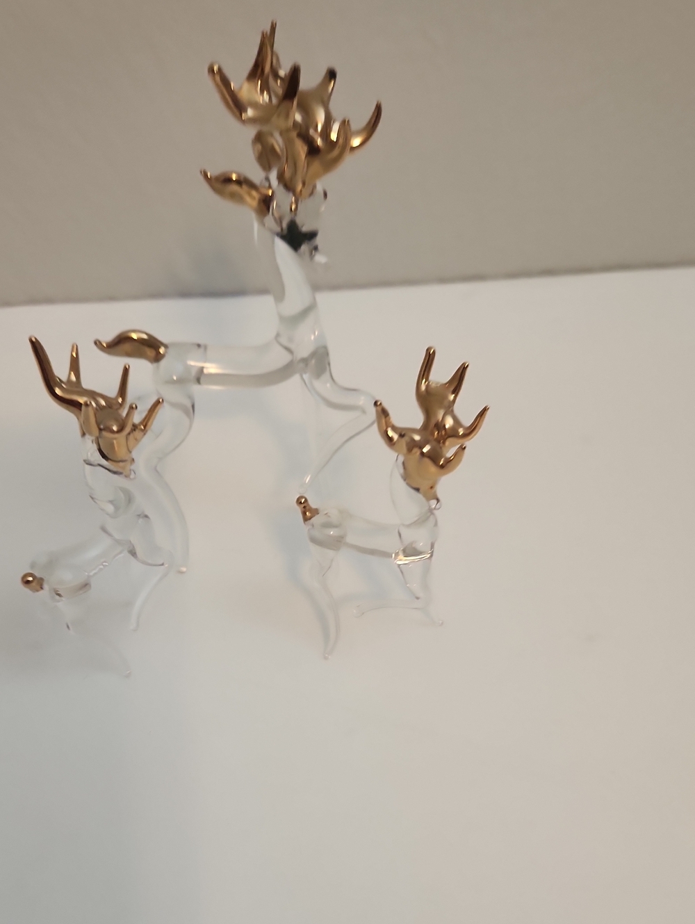 Hand-blown clear glass reindeer figurine set featuring delicate gold-accents